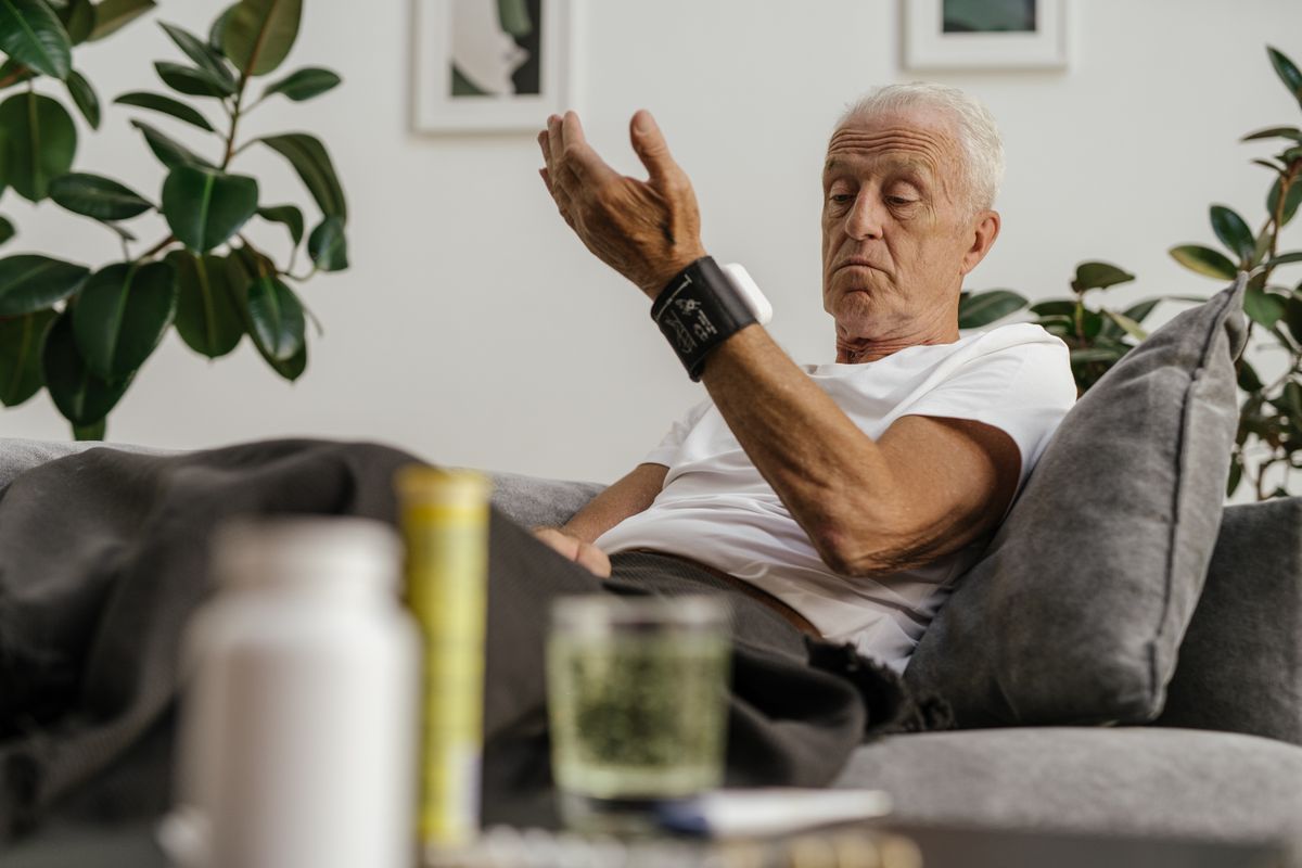 Adult at home reviewing a health monitoring device